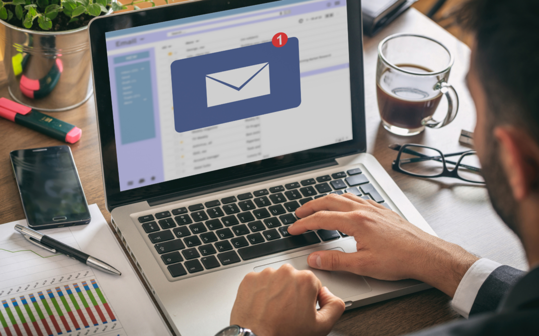 Man working on his laptop and receiving an email notification.